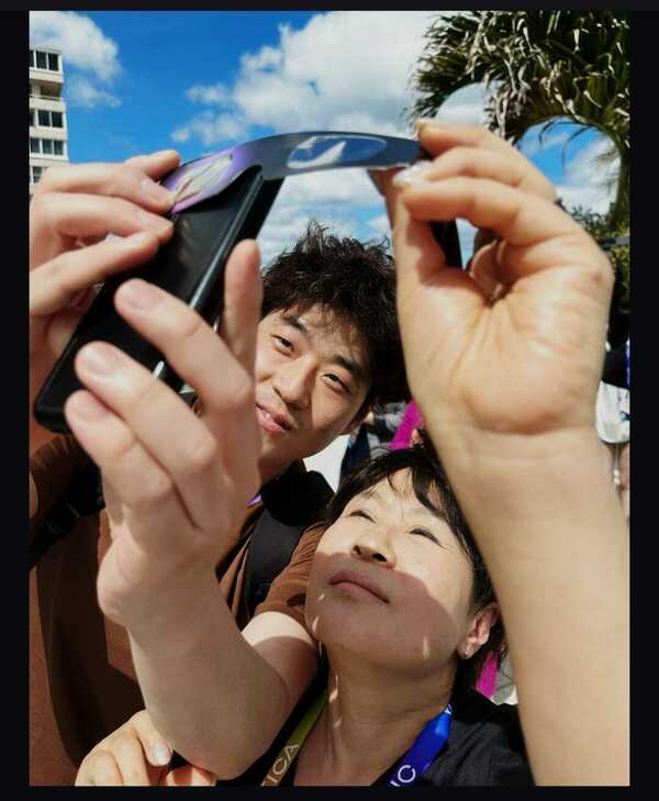 Sunghoon and his mother viewing the eclipse
